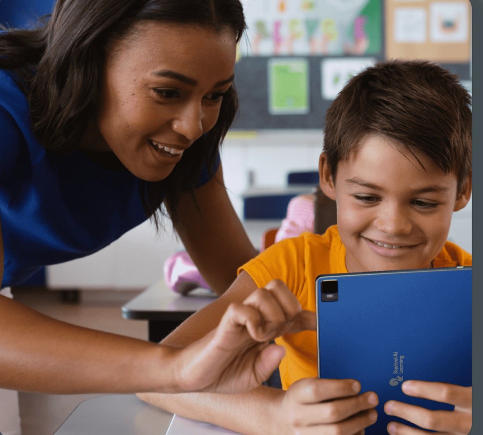 A Supervisor guides a smiling student through a lesson on a Squirrel Ai tablet.